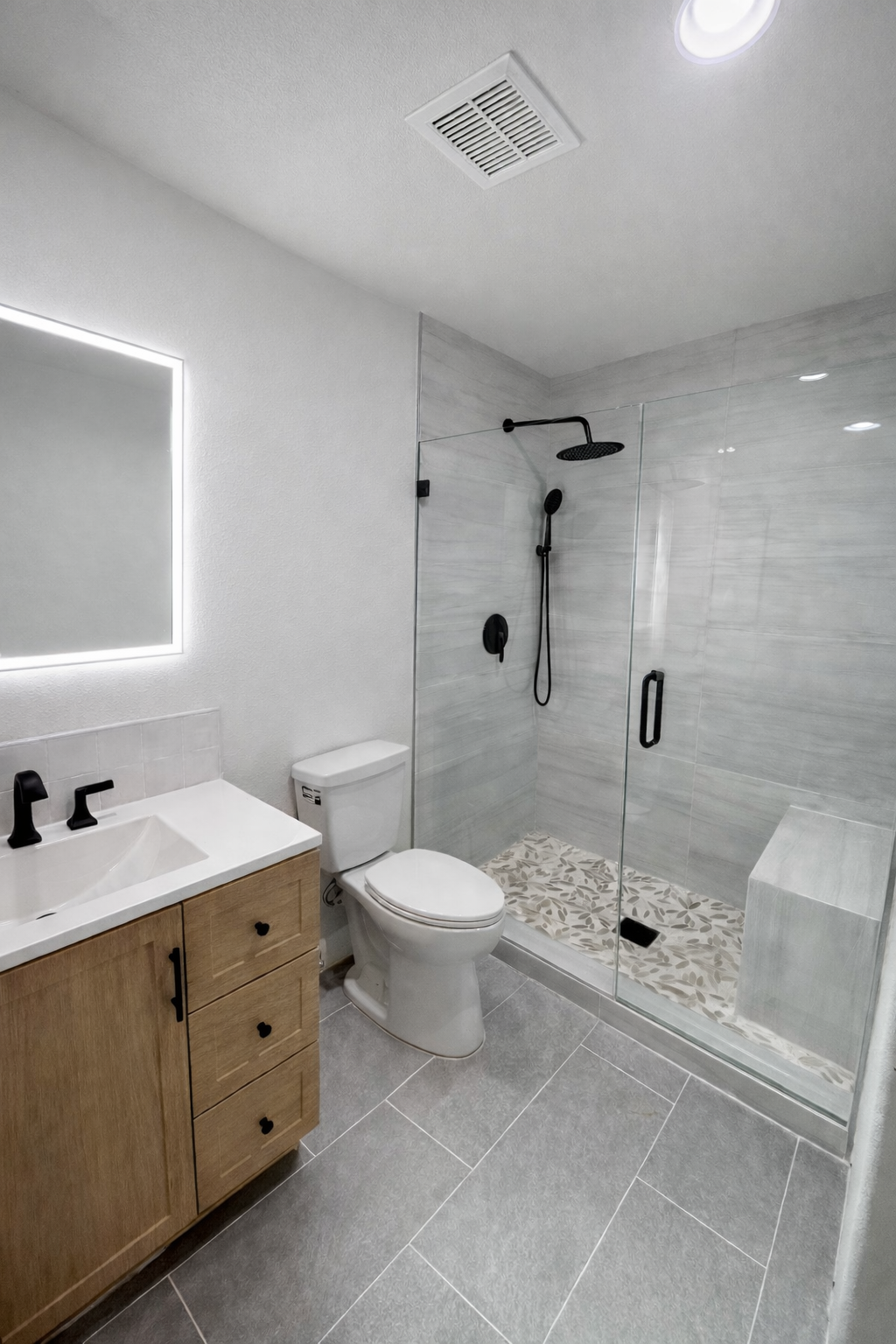 Gray bathroom with mosaic shower pan